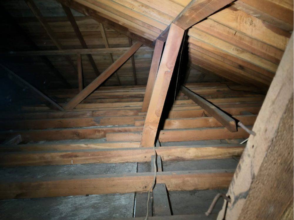 Uninsulated ceiling space with bare timber joists